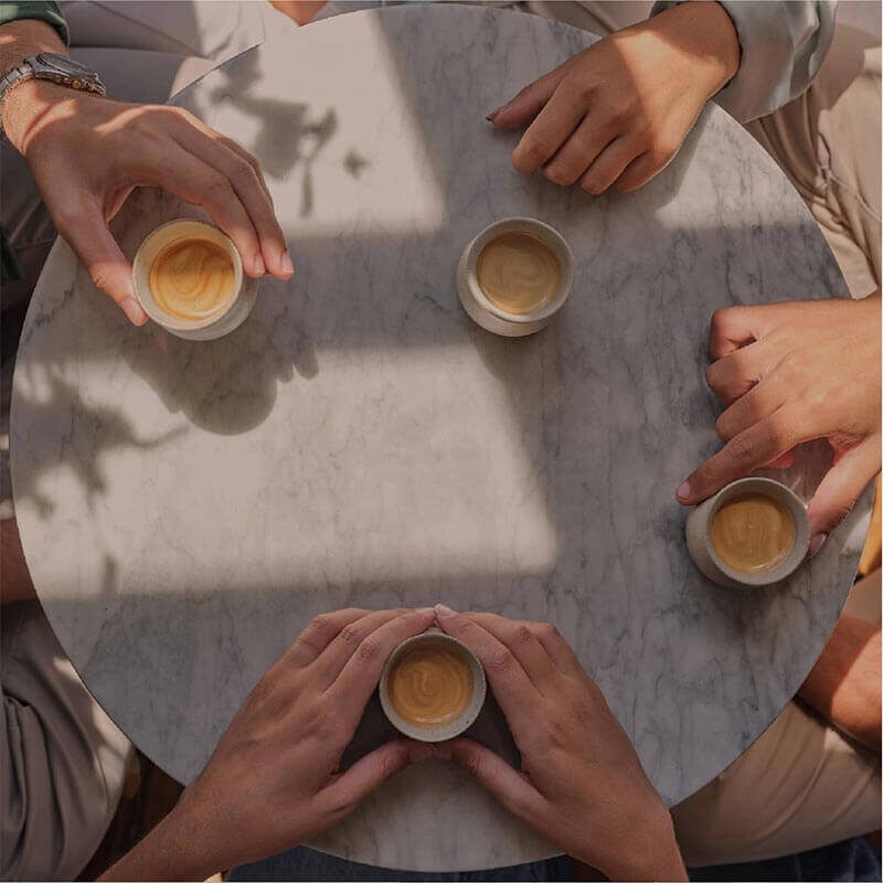 Social post: hands around coffee cups