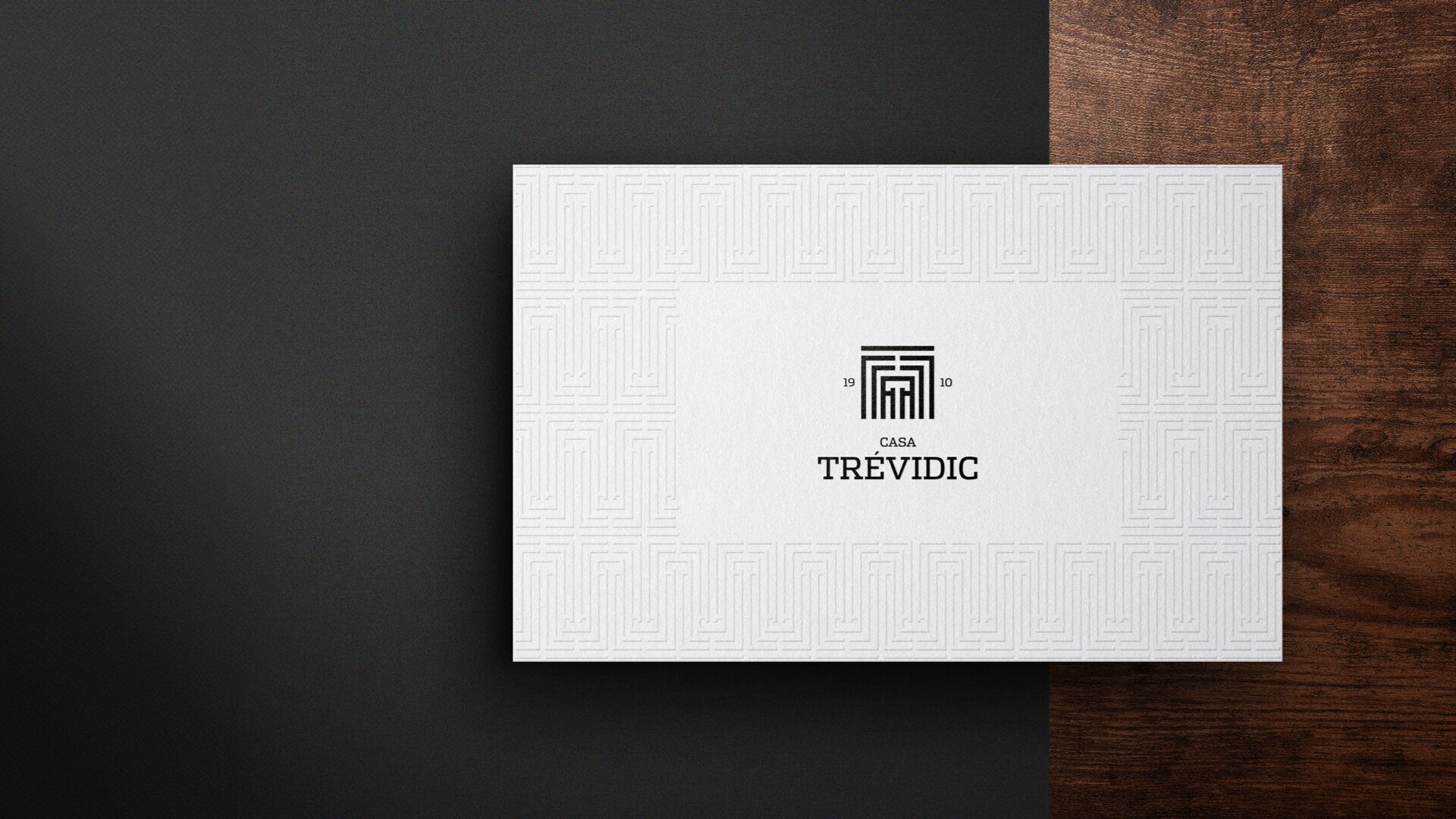 Casa Trévidic business card on dark wood